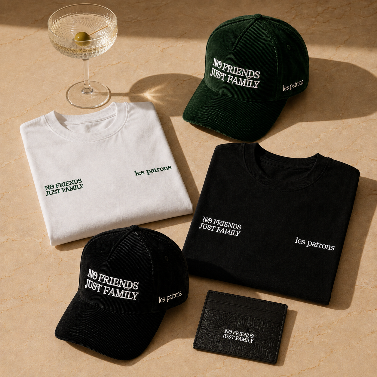 The NFJF collection — hats, tees and wallet on travertine